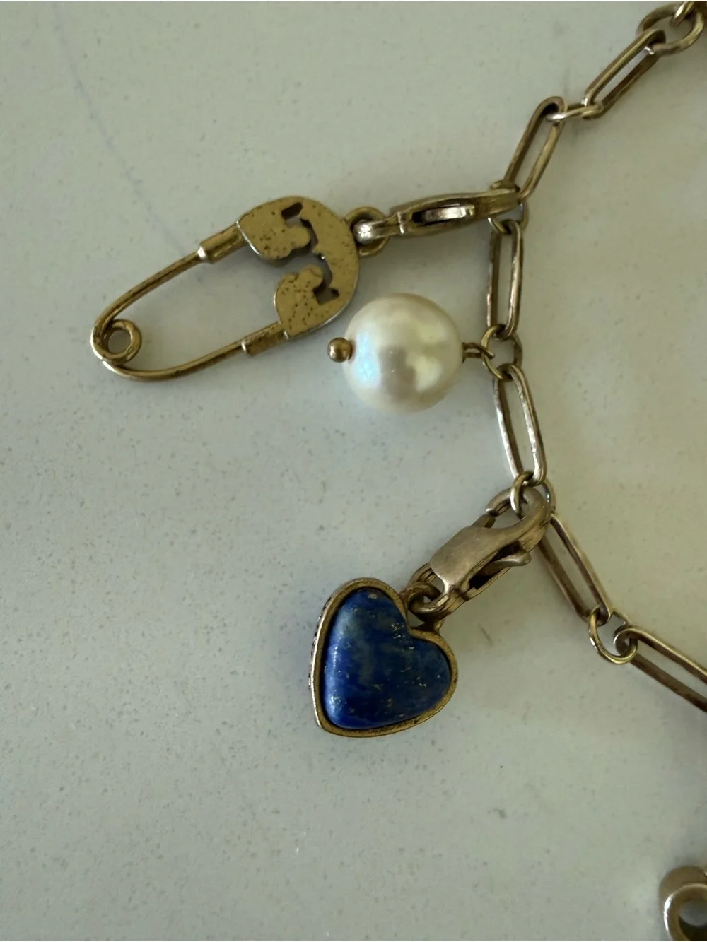 Gold tone Tory Burch beautiful bracelet with charms.